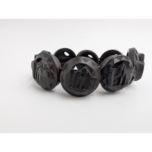 37 - Five 19th C. Irish bog oak brooches, two bracelets and two cross pendants.