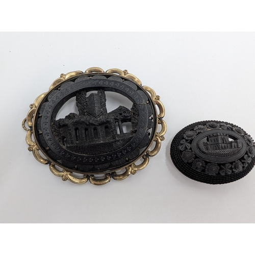 37 - Five 19th C. Irish bog oak brooches, two bracelets and two cross pendants.