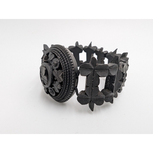 37 - Five 19th C. Irish bog oak brooches, two bracelets and two cross pendants.