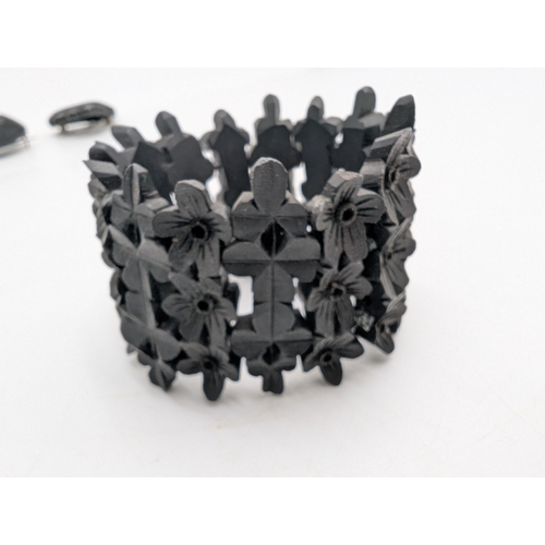 38 - Two 19th C. Irish bog oak crosses, three bracelets and three brooches.