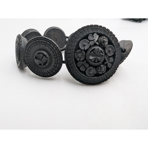 38 - Two 19th C. Irish bog oak crosses, three bracelets and three brooches.