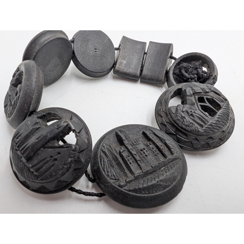 38 - Two 19th C. Irish bog oak crosses, three bracelets and three brooches.