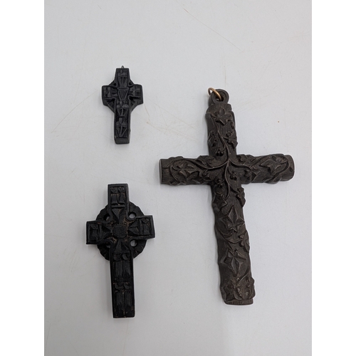 39 - Three 19th C. Irish bog oak crosses, three bracelets and three brooches.