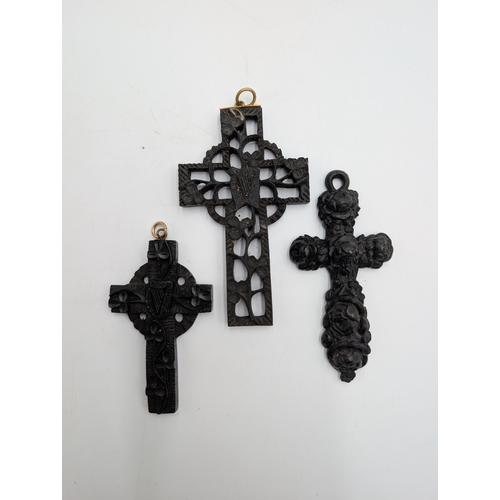 41 - Three 19th C. Irish bog oak crosses, three bracelets and three brooches.