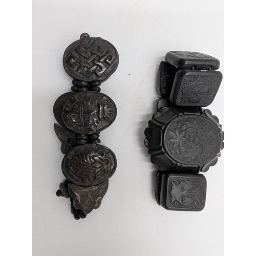 41 - Three 19th C. Irish bog oak crosses, three bracelets and three brooches.