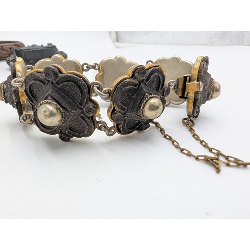 42 - Three 19th C. Irish bog oak bracelets, three brooches and single cross pendant.