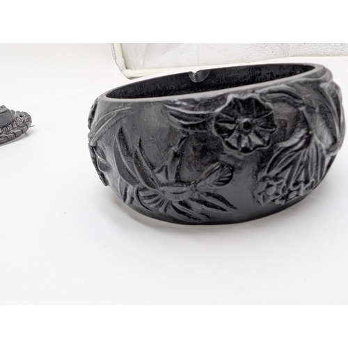 42 - Three 19th C. Irish bog oak bracelets, three brooches and single cross pendant.