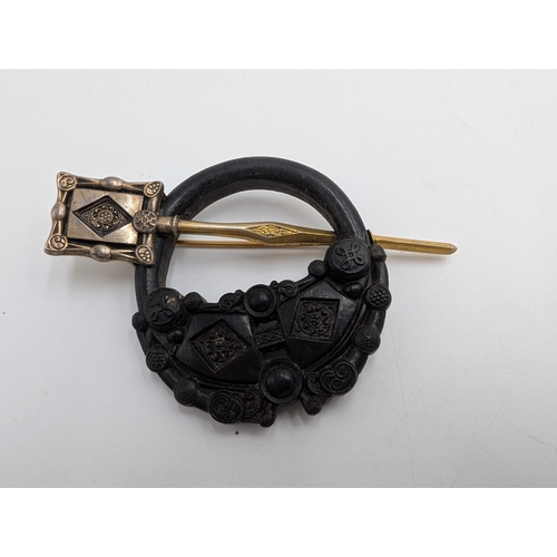 42 - Three 19th C. Irish bog oak bracelets, three brooches and single cross pendant.