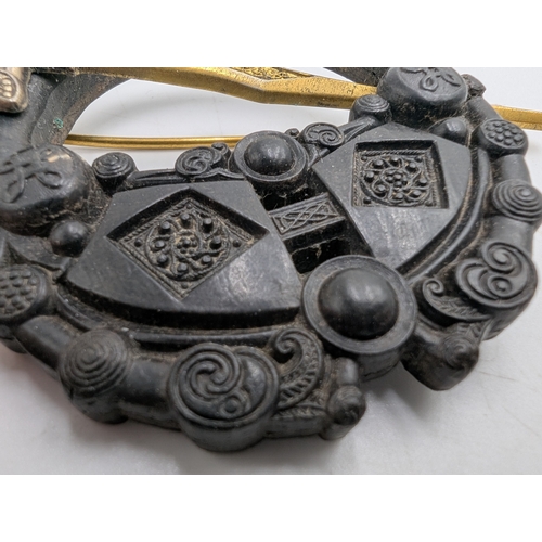 42 - Three 19th C. Irish bog oak bracelets, three brooches and single cross pendant.