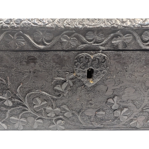 5 - 19th C. Irish bog oak dome topped writing box carved with Shamrocks and Harps. {14 cm H x 24 cm W x ... 