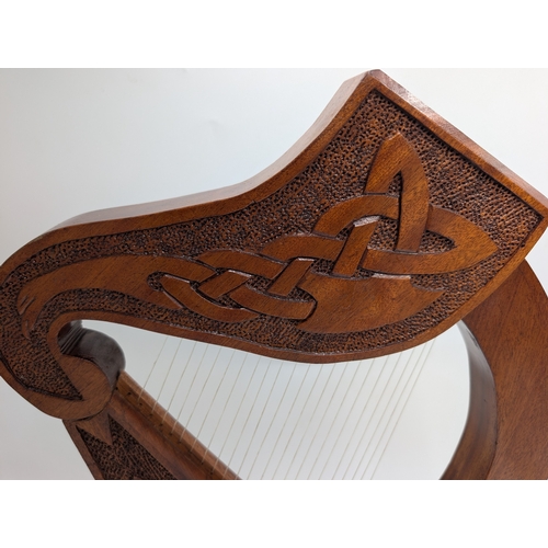 55 - Mahogany Irish Prison Art model of Celtic Harp. {21 cm H x 38 cm W x 17 cm D}.