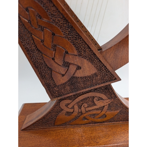 55 - Mahogany Irish Prison Art model of Celtic Harp. {21 cm H x 38 cm W x 17 cm D}.