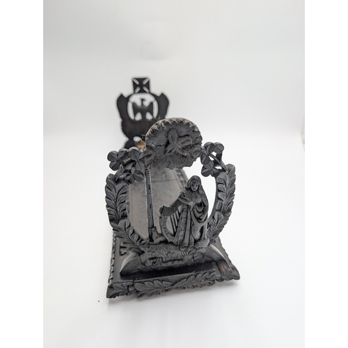 92 - 19th C. Irish carved bog oak book stand depicting Queen Maeve with a Harp and Eagle. {18 cm H x 49 c... 