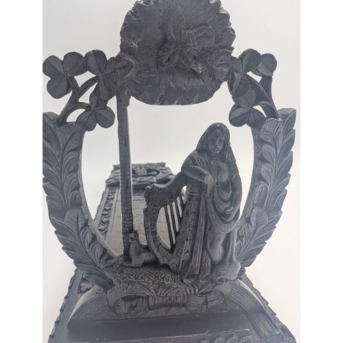 92 - 19th C. Irish carved bog oak book stand depicting Queen Maeve with a Harp and Eagle. {18 cm H x 49 c... 