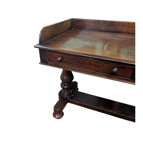 37 - William IV mahogany gallery back washstand on turned columns and platform base with two short drawer... 