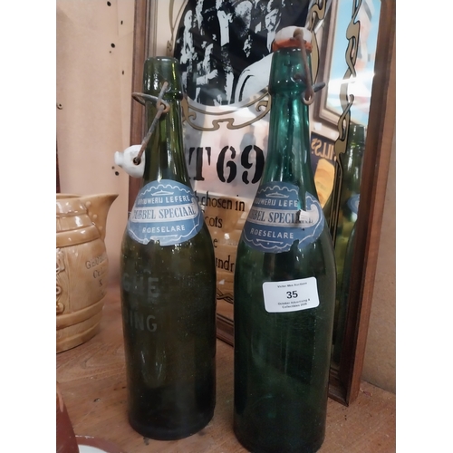 35 - Two Brouweru Lefrere Bubbel Speciaal Roeselare glass advertising bottles. {31 cm H x 8 cm Dia.}.