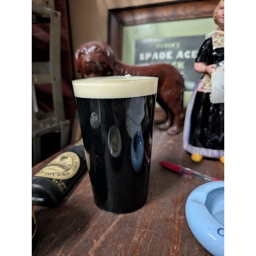 8 - Guinness plastic model of pint glass {14 cm H x 8 cm Dia.}  and Guinness bottle. {18 cm H x 5 cm W}.