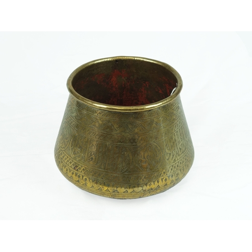 43 - Mamluk Style Engraved Brass Bowl, 19th Century 

Of deep rounded form with sides tapering to rounded... 