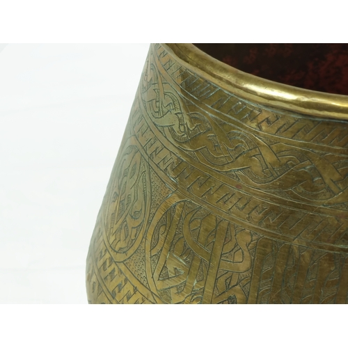 43 - Mamluk Style Engraved Brass Bowl, 19th Century 

Of deep rounded form with sides tapering to rounded... 