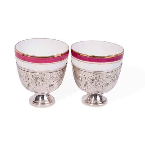 121 - A PAIR OF OTTOMAN SILVER ZARF WITH RUSSIAN KUZNETZOV PORCELAIN CUPS, OTTOMAN TURKEY, 19TH CENTURY

A... 