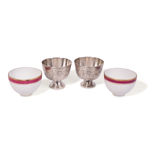 121 - A PAIR OF OTTOMAN SILVER ZARF WITH RUSSIAN KUZNETZOV PORCELAIN CUPS, OTTOMAN TURKEY, 19TH CENTURY

A... 