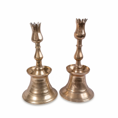 89 - A PAIR OF OTTOMAN BRASS TULIP CANDLESTICKS, TURKEY, 18TH CENTURY

Rising from a conical base through... 