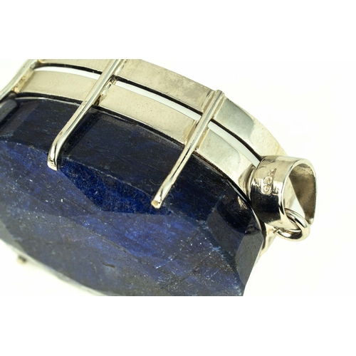 102 - Oval Shaped Faceted Corundum / Sapphire, Set As A Pendant In Silver 

50mm long 
36mm wide 
106 gram... 