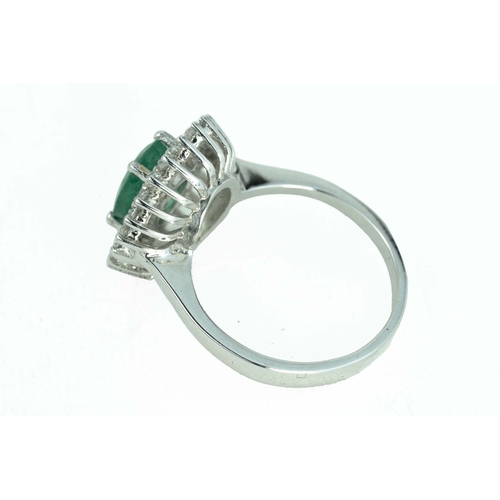 79 - Emerald and Diamond White Gold Ring

An oval-shaped emerald, surrounded by two rows of round diamond... 