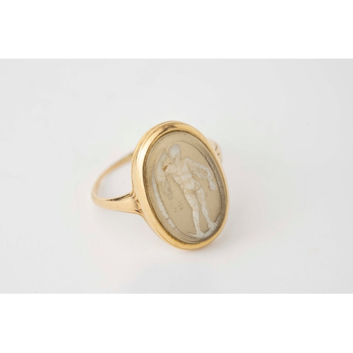 12 - Gold and Glass Cameo Ring   

An antique gold and glass ring, the oval signet style ring with centra... 