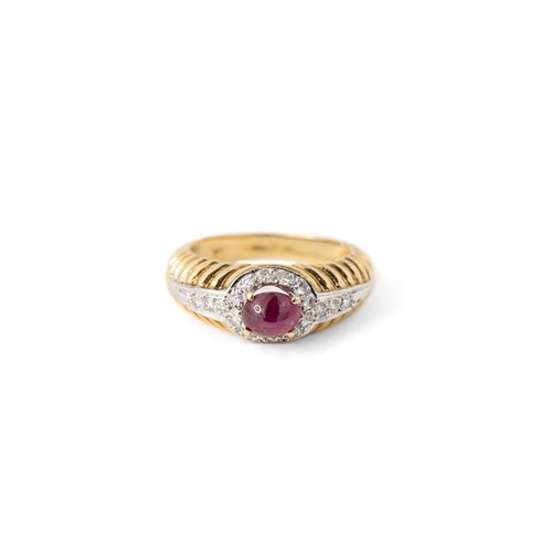 41 - A Ruby and Diamond Ring   

A cabochon ruby and diamond ring, a round ruby gemstone elevated and sec... 