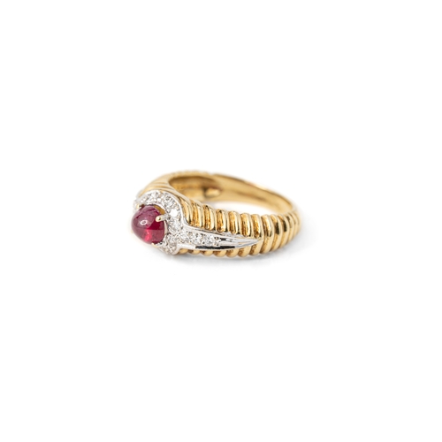 41 - A Ruby and Diamond Ring   

A cabochon ruby and diamond ring, a round ruby gemstone elevated and sec... 