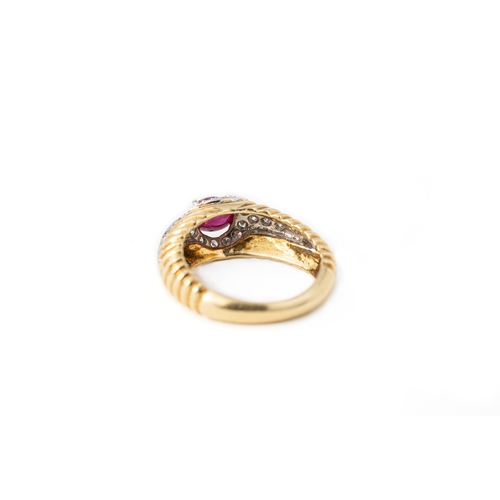 41 - A Ruby and Diamond Ring   

A cabochon ruby and diamond ring, a round ruby gemstone elevated and sec... 