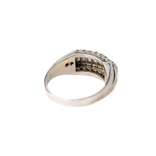 51 - A Diamond White Gold Band Ring

A diamond ring with a sequence of baguette stones with tiers of roun... 