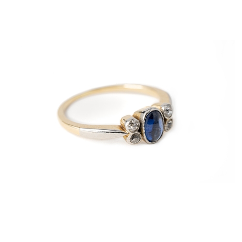 52 - A Sapphire and Diamond Ring

A cabochon sapphire and diamond ring, an oval-shaped sapphire to centre... 