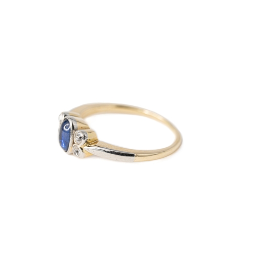 52 - A Sapphire and Diamond Ring

A cabochon sapphire and diamond ring, an oval-shaped sapphire to centre... 