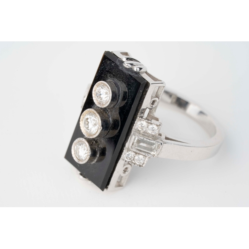 6 - Onyx and Diamond Art Deco White Gold Ring   

A white gold ring in the style of Art-Deco featuring a... 