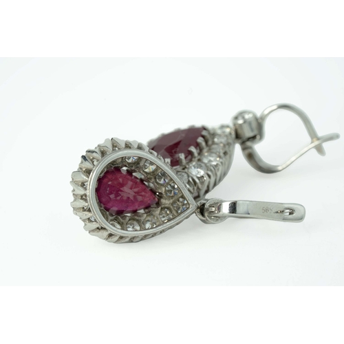 60 - A Pair Of Ruby And Diamond Earrings  

A pair of diamond earrings with two pear-shaped 7mm wide rubi... 