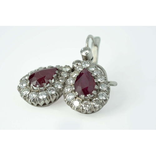 60 - A Pair Of Ruby And Diamond Earrings  

A pair of diamond earrings with two pear-shaped 7mm wide rubi... 