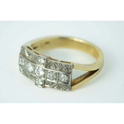 65 - A Cross-Shaped Diamond Gold Ring 

A diamond ring, set with round diamonds in a cross-shaped millgra... 