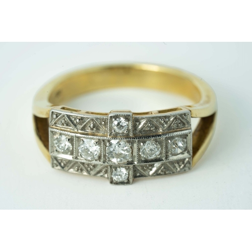 65 - A Cross-Shaped Diamond Gold Ring 

A diamond ring, set with round diamonds in a cross-shaped millgra... 