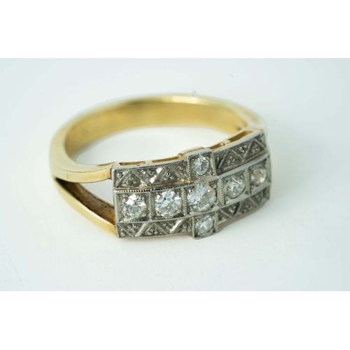 65 - A Cross-Shaped Diamond Gold Ring 

A diamond ring, set with round diamonds in a cross-shaped millgra... 