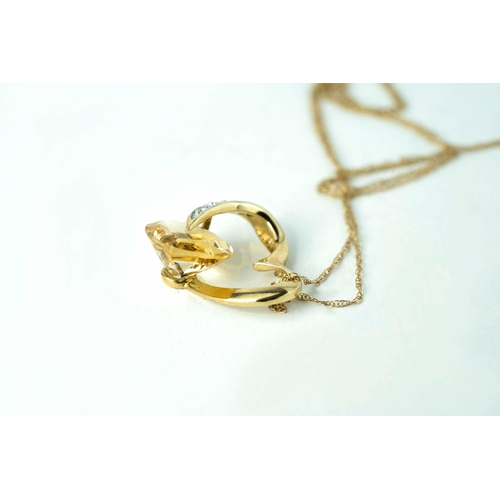 69 - A Citrine and Diamond Heart-Shaped Pendant On 40cm Long Chain

A heart-shaped gold pendant, accentua... 