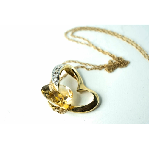 69 - A Citrine and Diamond Heart-Shaped Pendant On 40cm Long Chain

A heart-shaped gold pendant, accentua... 