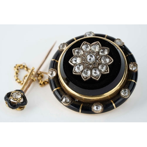 8 - Onyx and Diamond Brooch    

Of circular shape, the black onyx accented by a flower head in the cent... 