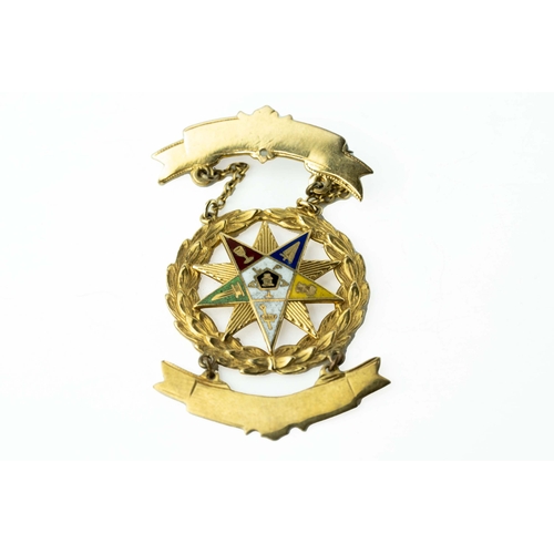 82 - Gold and Enamel Masonic Medal

A masonic medal showcasing a ten-pointed star positioned within a wre... 