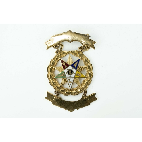 82 - Gold and Enamel Masonic Medal

A masonic medal showcasing a ten-pointed star positioned within a wre... 