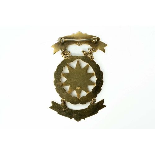 82 - Gold and Enamel Masonic Medal

A masonic medal showcasing a ten-pointed star positioned within a wre... 