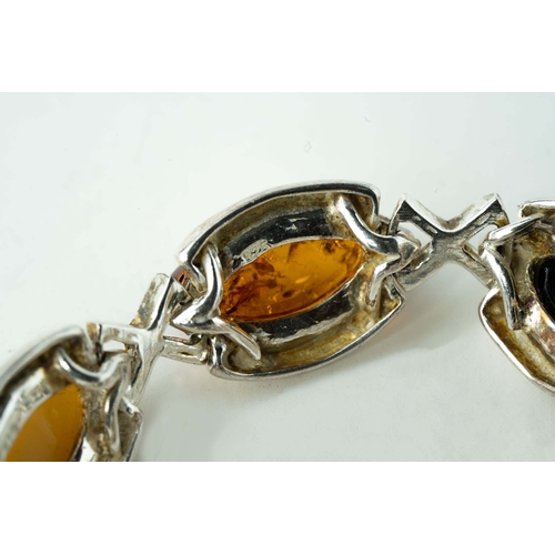 89 - Silver And Amber Bracelet

A bracelet crafted from silver, adorned with a collection of eight amber ... 