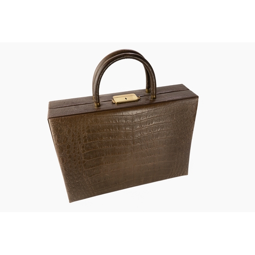 145 - A Crocodile Leather Travel Bag  

A crocodile-patterned travel bag featuring a lock and key mechanis... 