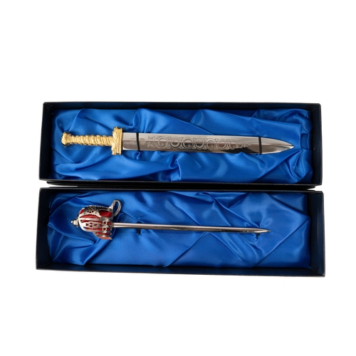 149 - A Pair Of Wilkinson Miniature Swords  

Comprising a highland regiment pattern basket hilted sword a... 